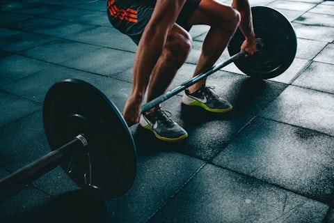 Person performing strength exercises in gym